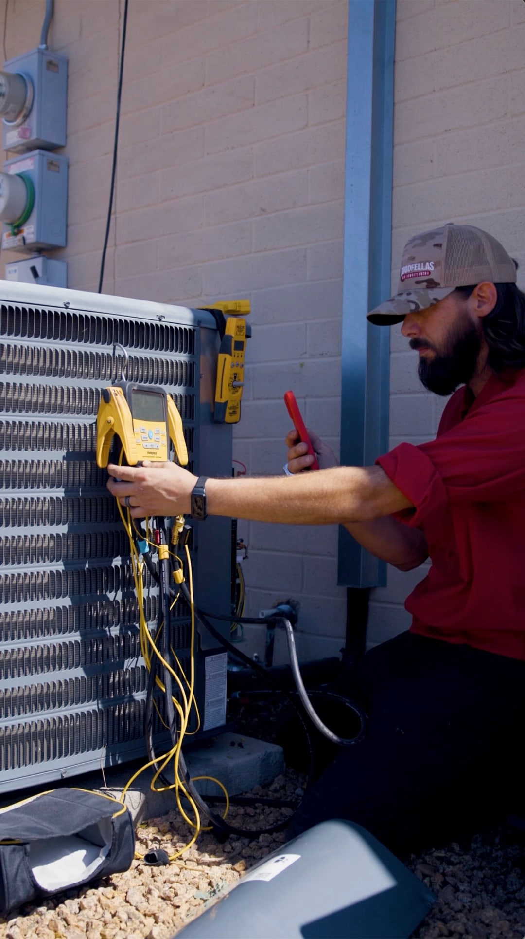 A real GoodFellas technician running a full inspection on a Tucson AC system